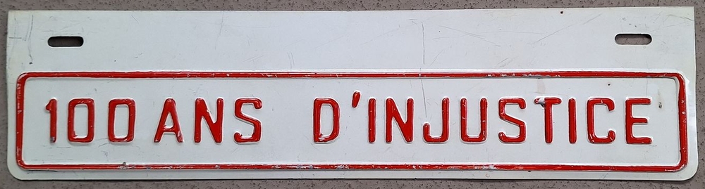 Enseigne 100 ans d'injustice